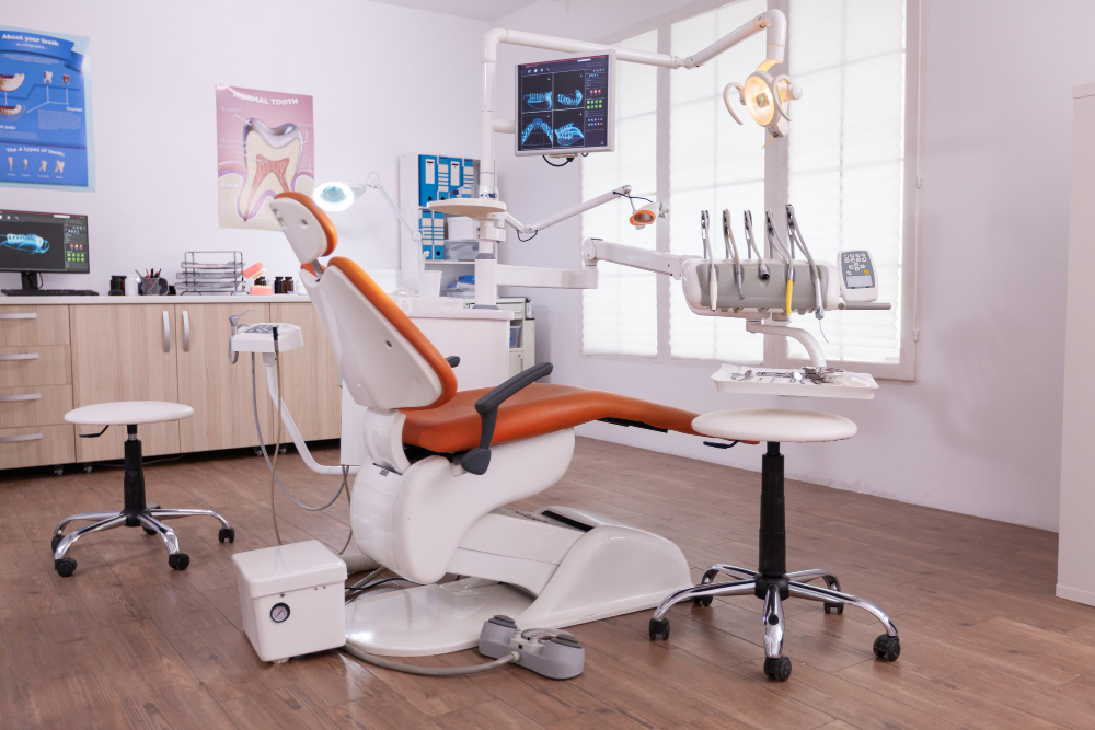 The image shows a dental office with a dental chair, a computer, and other dental equipment.